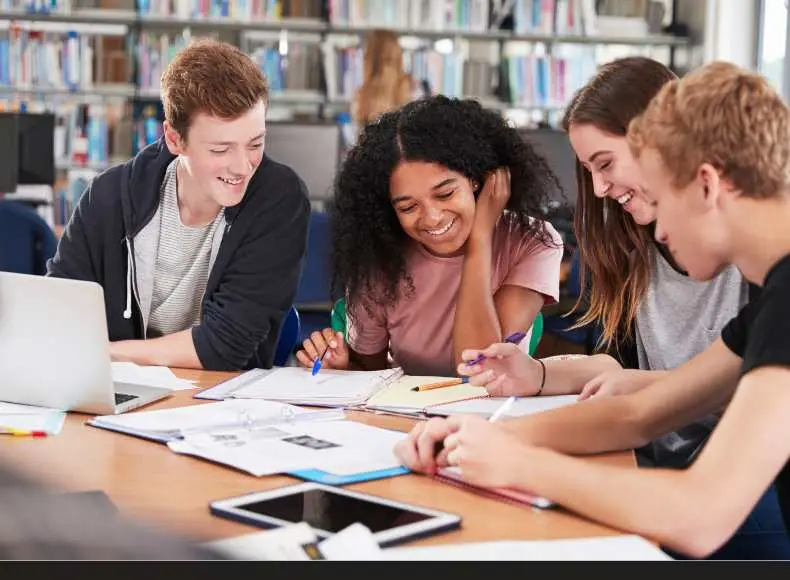 Teens collaborating on a business project, showcasing creativity, teamwork, and the entrepreneurial spirit in a vibrant learning environment.”